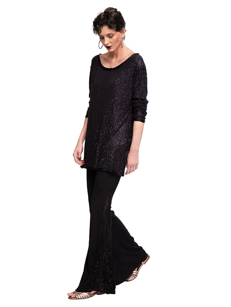 Nyx beaded mini black dress styled with Hendrix bell bottom pants and Margot heels, side view - worn by model