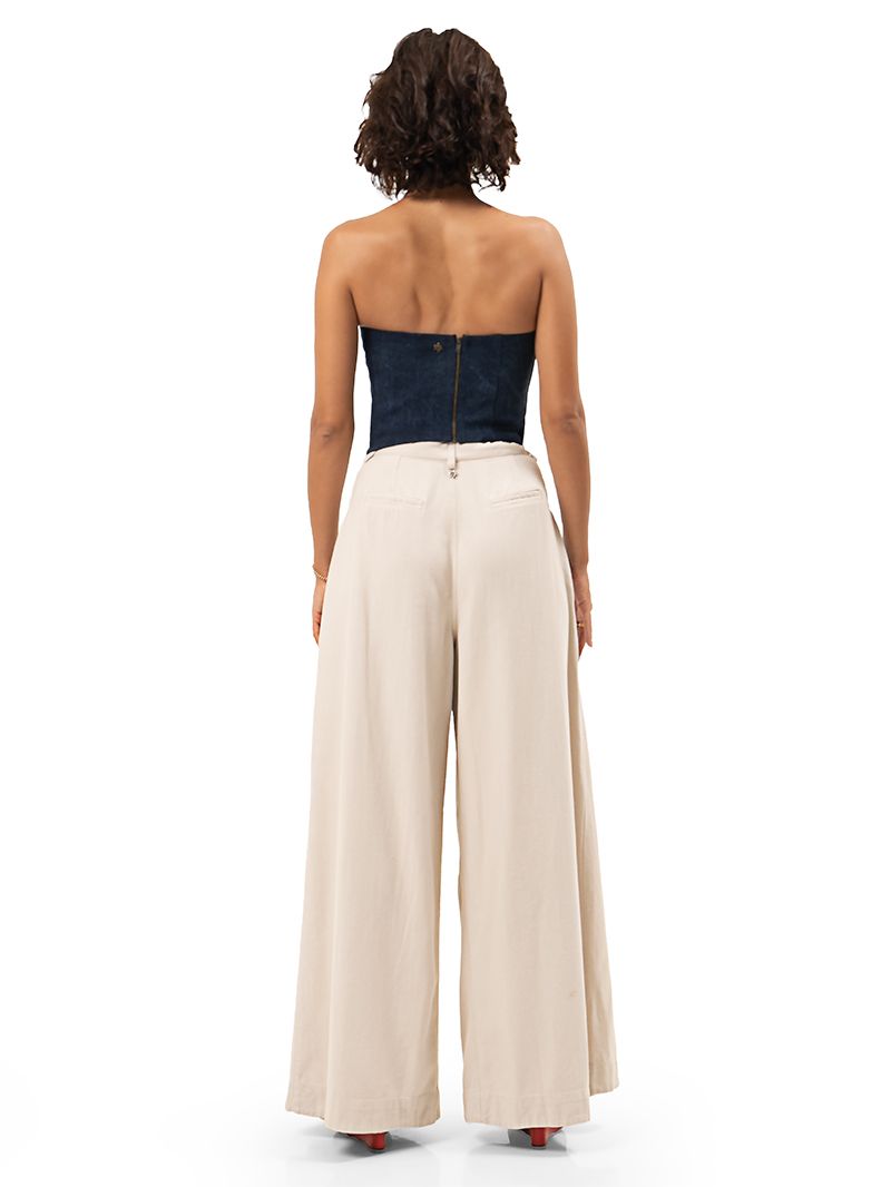 Joplin bustier in blue denim styled with Rua pants in Titanium color, and Sasha red wedges, back view - worn by model