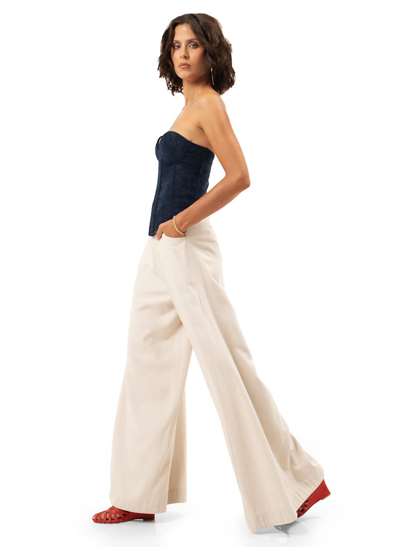 Joplin bustier in blue denim styled with Rua pants in Titanium color, and Sasha red wedges, side view - worn by model