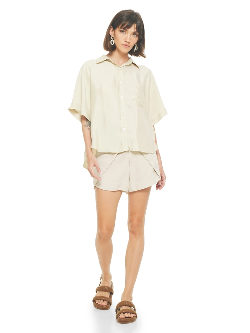 Dian shorts in beige styled with Paris shirt and Charlie flats, front view -worn by model