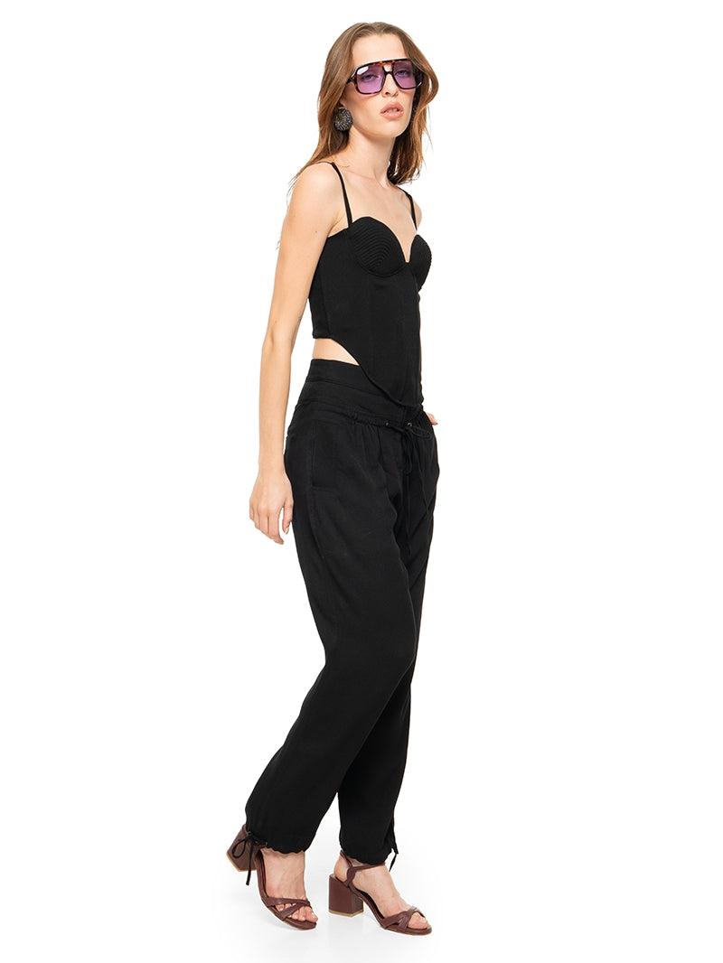 Luma pants in black styled with Anggie bustier top and Esther heels, side left view - worn by model