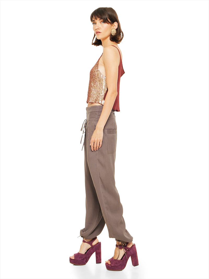 Luma pants in elephant warm grey taupe styled with Hora beaded tank top and Betty heels, side view - worn by model