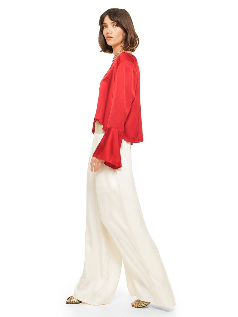 Nova pants in vanilla color styled with Rama top and Margot heels, side view - worn by model