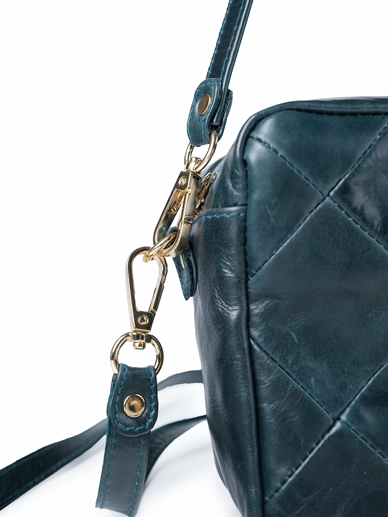 Rimba leather shoulder bag with a diamond-quilted pattern, featuring matching detachable shoulder and crossbody straps with gold-tone hardware - ghost closeup hardware details view