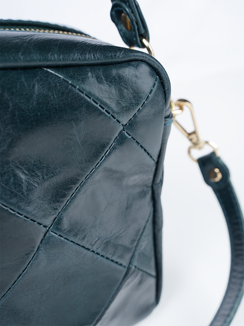 Rimba leather shoulder bag with a diamond-quilted pattern, featuring matching detachable shoulder and crossbody straps with gold-tone hardware - ghost diamond pattern front closeup view