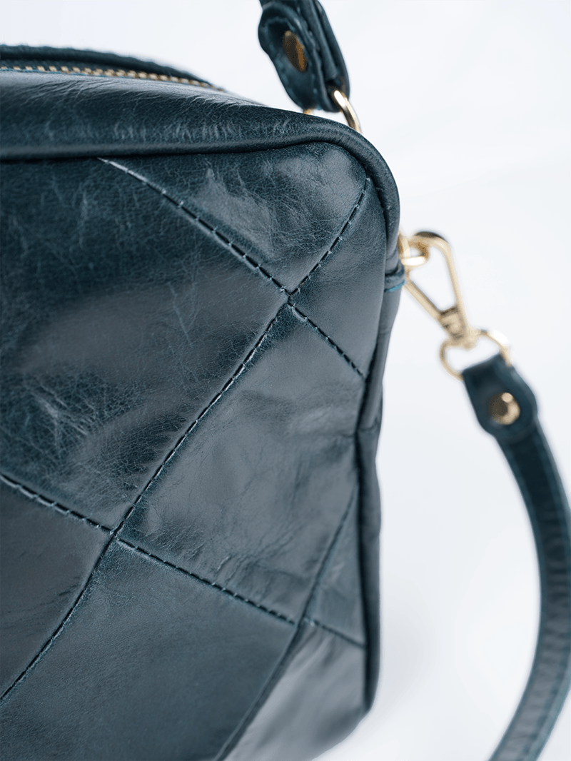 Rimba leather shoulder bag with a diamond-quilted pattern, featuring matching detachable shoulder and crossbody straps with gold-tone hardware - ghost diamond pattern front closeup view