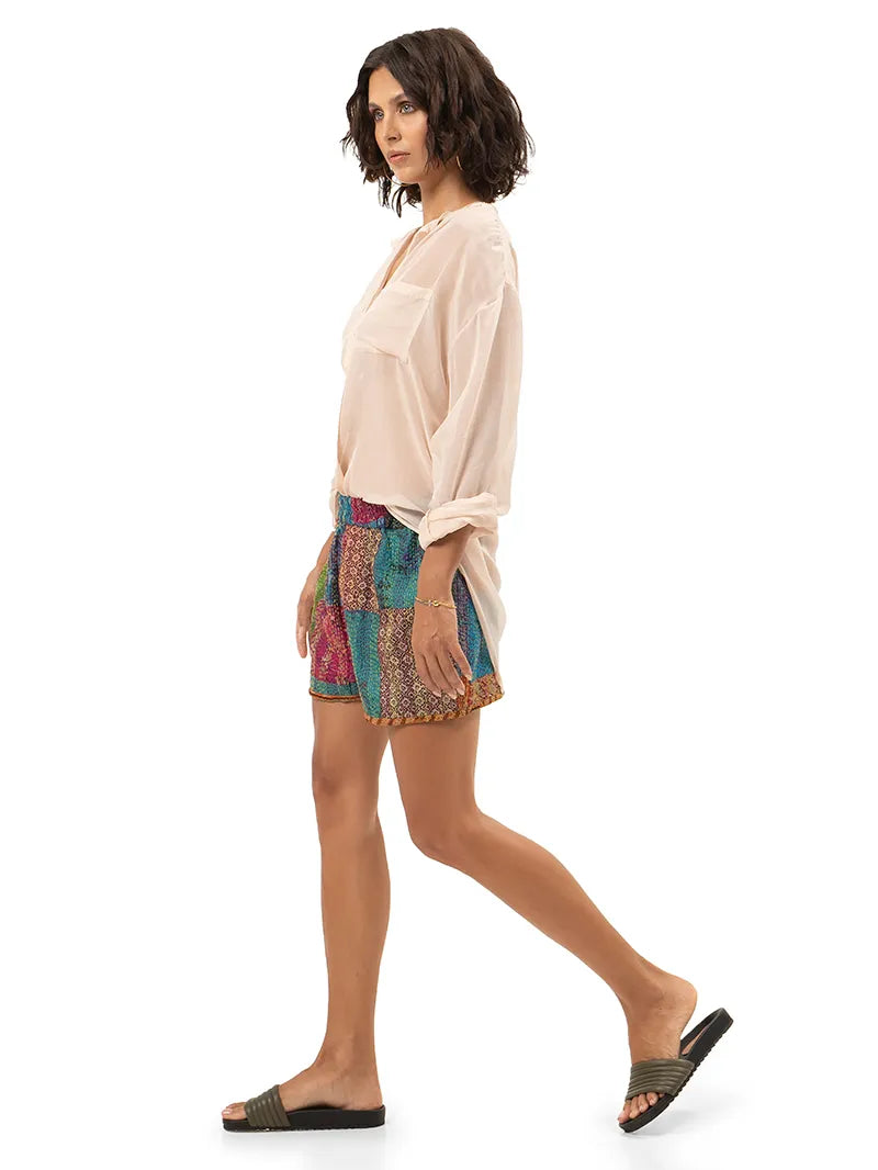 Arya shorts styled with Silk shirt and Flaviana slides, side view - worn by model