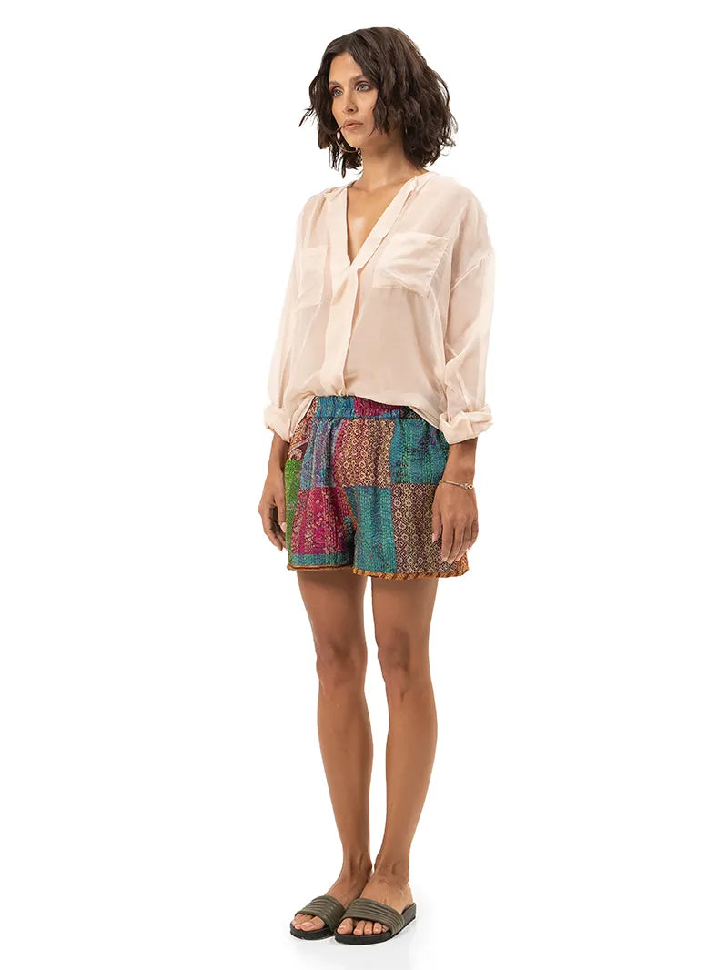 Arya shorts styled with Silk shirt and Flaviana slides, side view - worn by model
