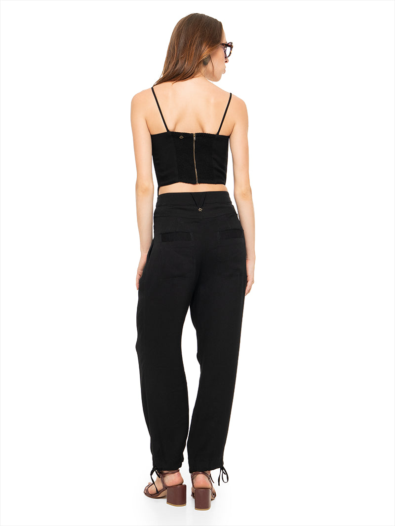 Angie bustier top in black styled with Luma pants and Esther heels, back view - worn by model 