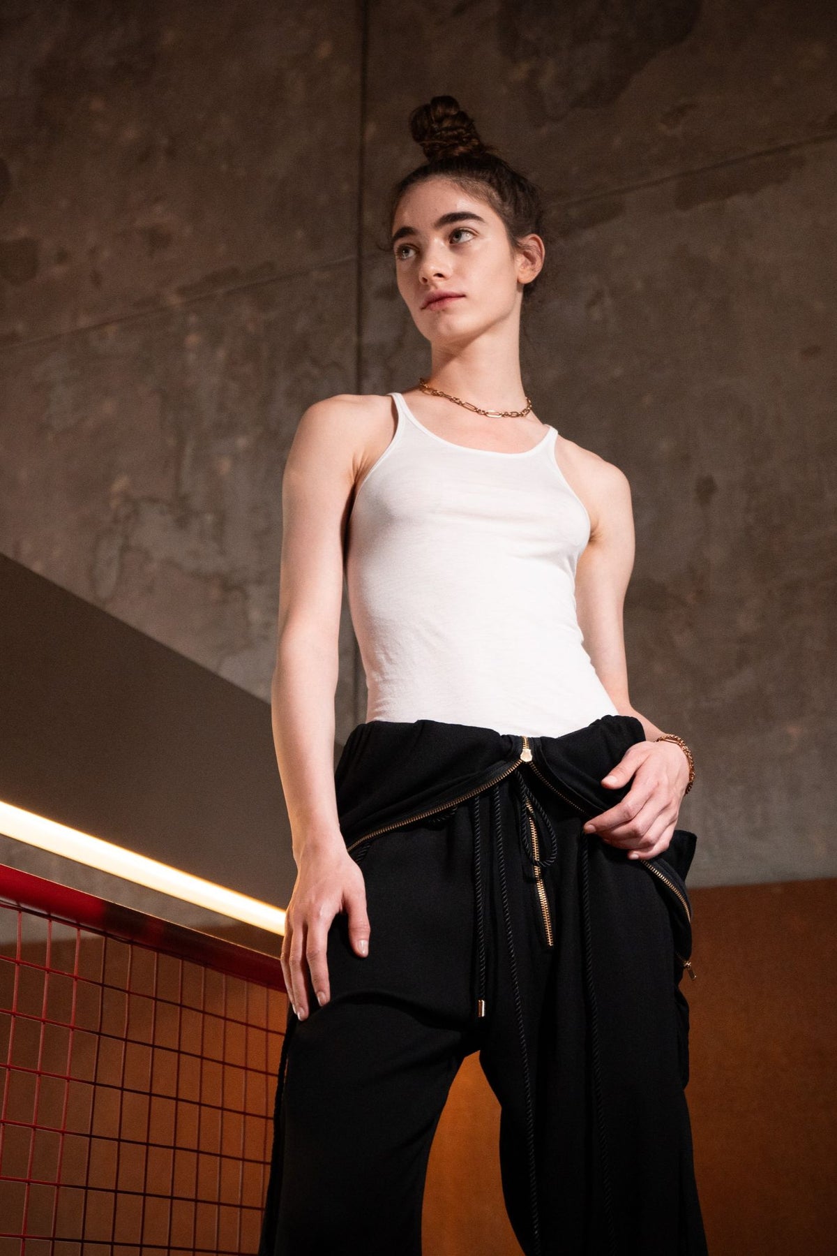 Berlin maxi jumpsuit in black styled as pants with white tank top, front view - worn by model