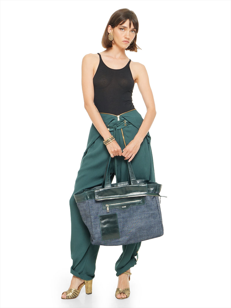 Berlin jumpsuit in pine green as pants styled with Freya black tank top, Margot heels, and Victoria tote bag - worn by model