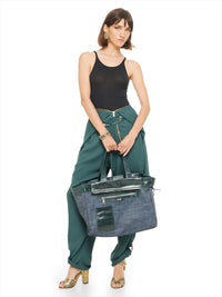 Berlin jumpsuit in pine green as pants styled with Freya black tank top, Margot heels, and Victoria tote bag - worn by model