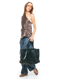 Ganesha top in elephant color, styled with Snap jeans pants, Margot flats, and Victoria tote bag in pine green, quarter front view - worn by model