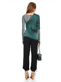 Ganesha top in pine green styled with Boga bodysuit, Luma pants, Margot heels, and Rimba bag, back view - worn by model