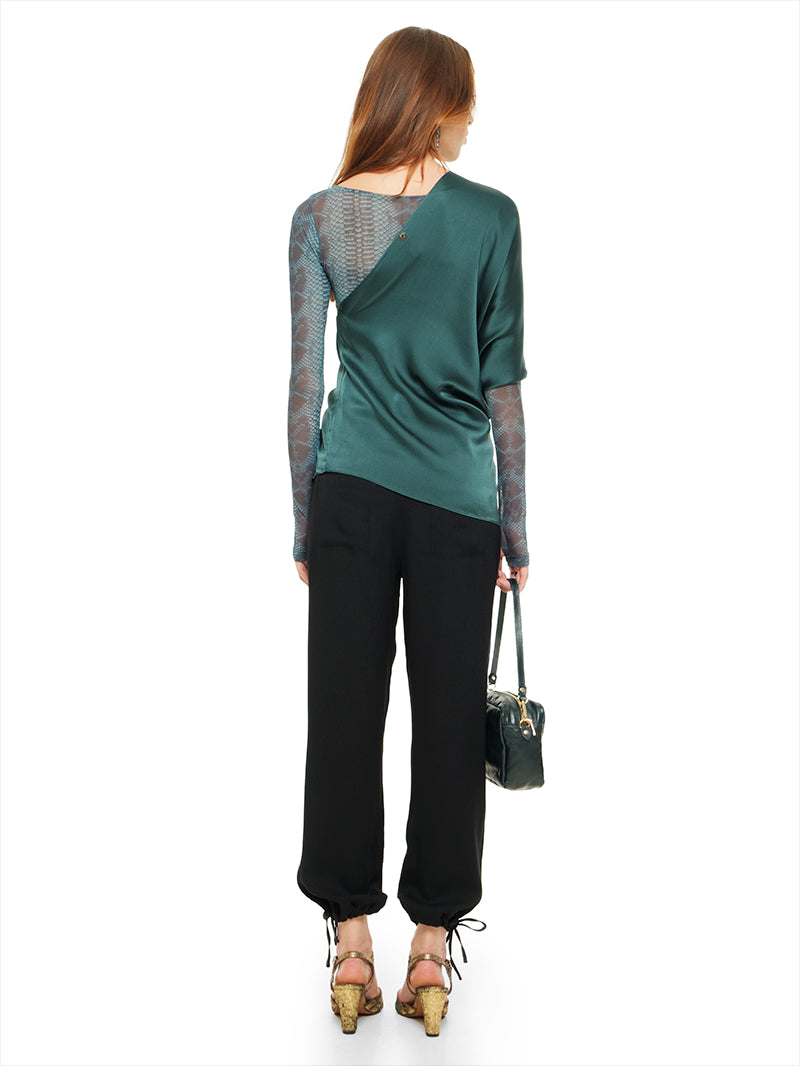 Ganesha top in pine green styled with Boga bodysuit, Luma pants, Margot heels, and Rimba bag, back view - worn by model