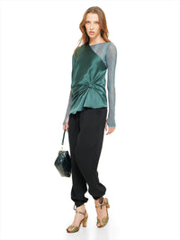 Ganesha top in pine green styled with Boga bodysuit, Luma pants, Margot heels, and Rimba bag, quarter front view - worn by model