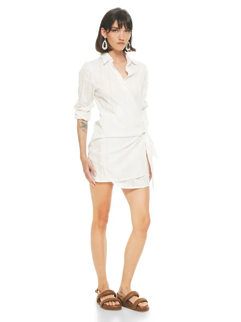 Kira mini wrap white dress styled with Charlie flats, front view - worn by model