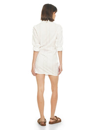 Kira mini dress in white styled with Charlie flats, back view - worn by model