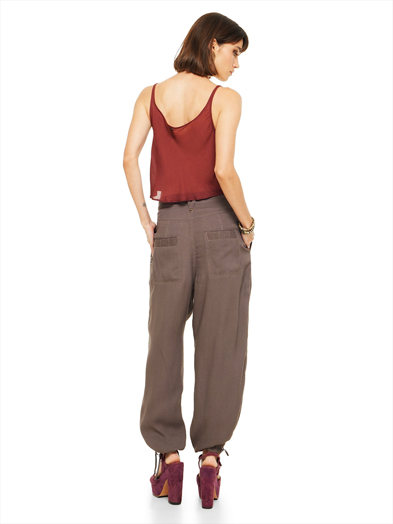 Luma pants in elephant warm grey taupe, styled with Hora beaded top and Betty heels, back view - worn by model