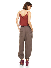 Luma pants in elephant warm grey taupe, styled with Hora beaded top and Betty heels, back view - worn by model