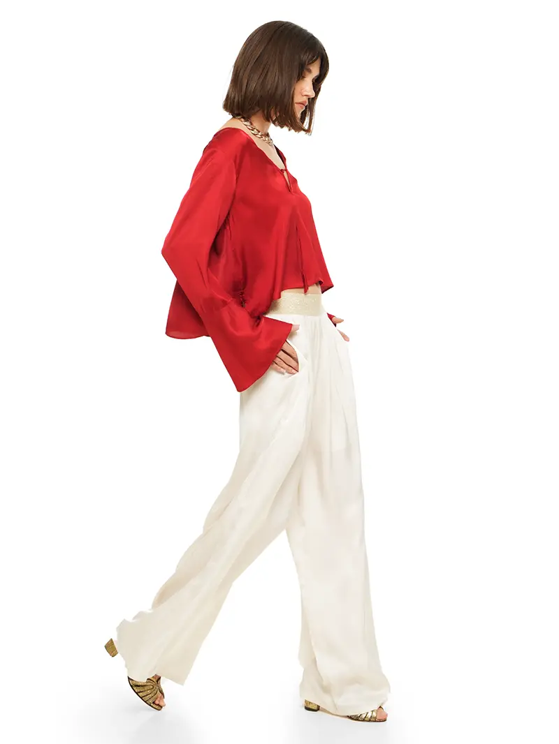 Nova pants in vanilla color styled with Rama top and Margot heels, side view - worn by model