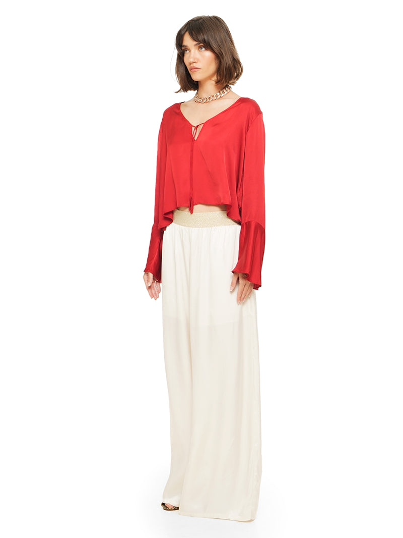 Nova pants in vanilla color styled with Rama top and Margot heels, quarter side view - worn by model