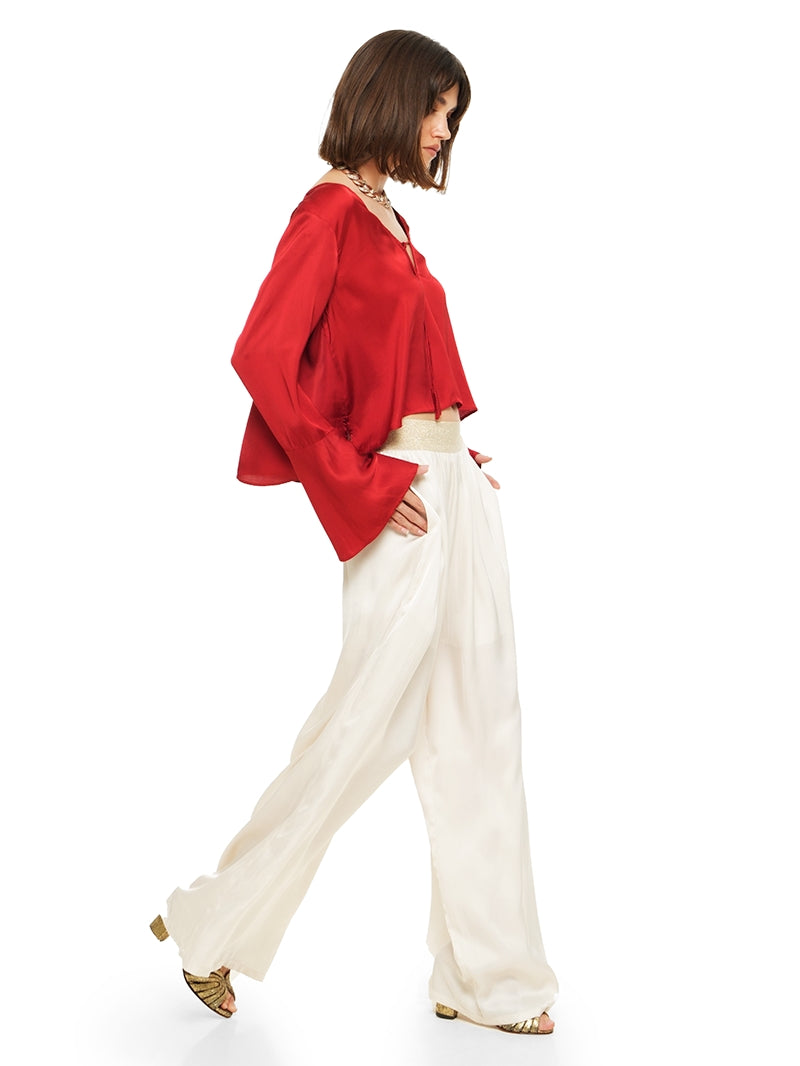 Nova pants in vanilla color styled with Rama top and Margot heels, side movement view - worn by model