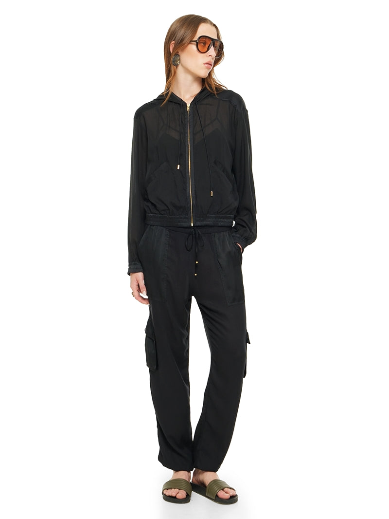 Sheer bomber jacket in black styled with Dega bodysuit, Cargo pants and Flaviana sildes, front view - worn by model