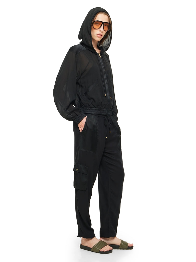 Sheer bomber jacket in black styled with Dega bodysuit, Cargo pants and Flaviana sildes, quarter front view - worn by model