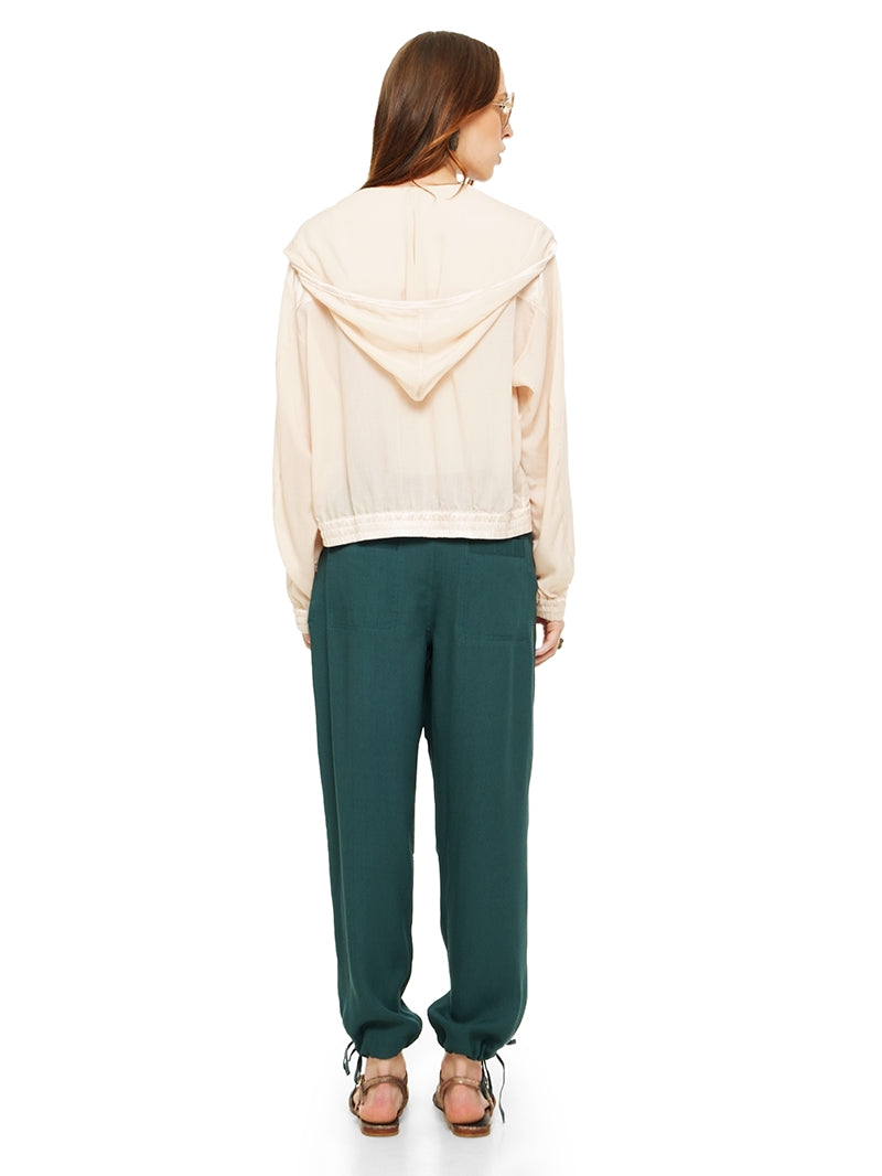 Sheer bomber jacket in blush styled with Luma pants and Margot flats, back view - worn by model
