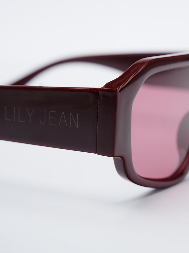 Rectangle sunglasses in deep wine frame with pink-tinted lenses - close-up view