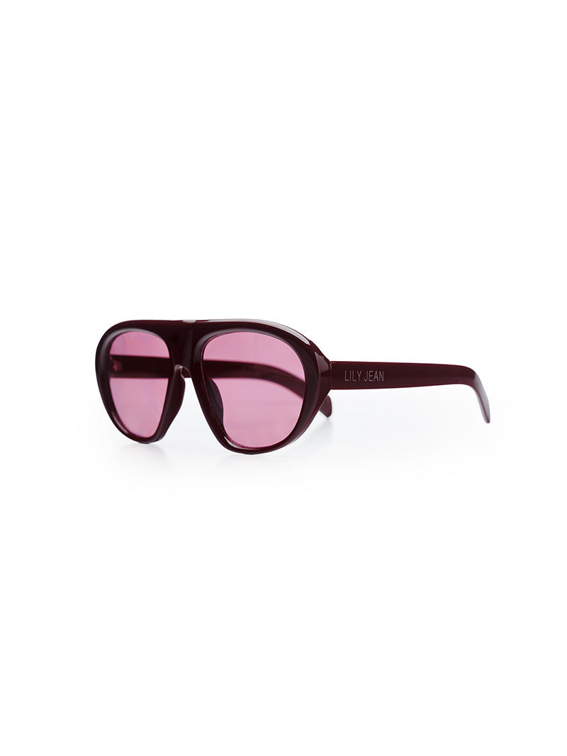 A pair of oversized sunglasses with pink-tinted lenses and a dark burgundy frame - front quarter view